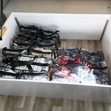 3 x large black trim clear camping bags packed with linen winter gear and shoes underneath caravan bed