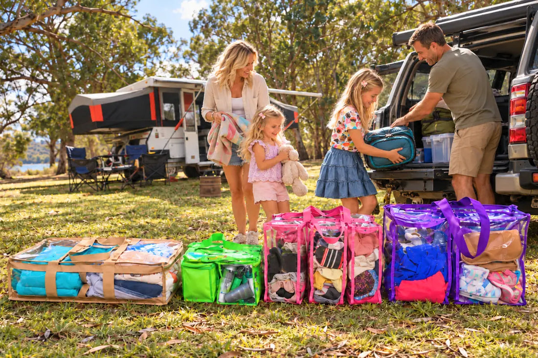 family in campground beside car and camper with 4 clear packed camp bags