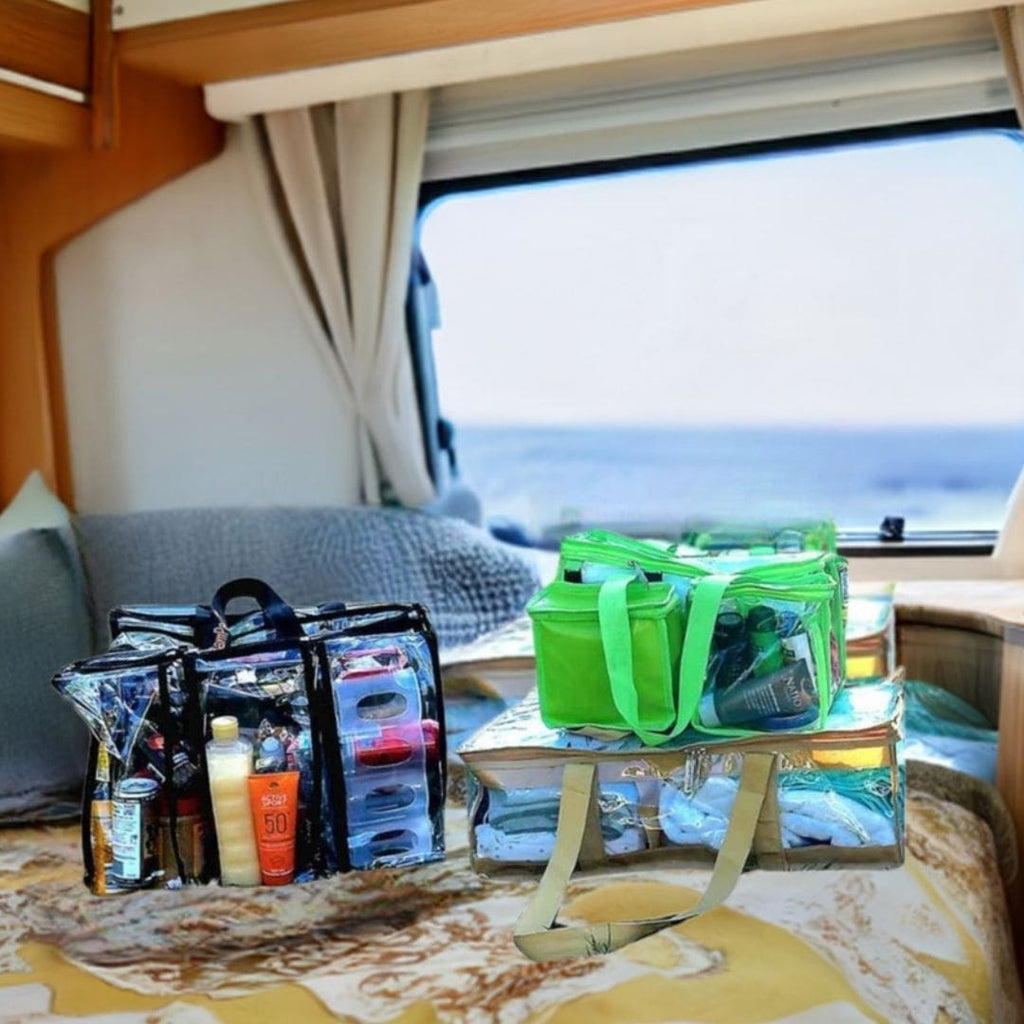 Under bed plus large plus toiletry CamPaq bags packed and sitting on caravan bed with a view of ocean