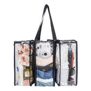 Clear medium black camping bag showing front 3 compartments containing clothing, camera, toiletries, sunglasses and various items