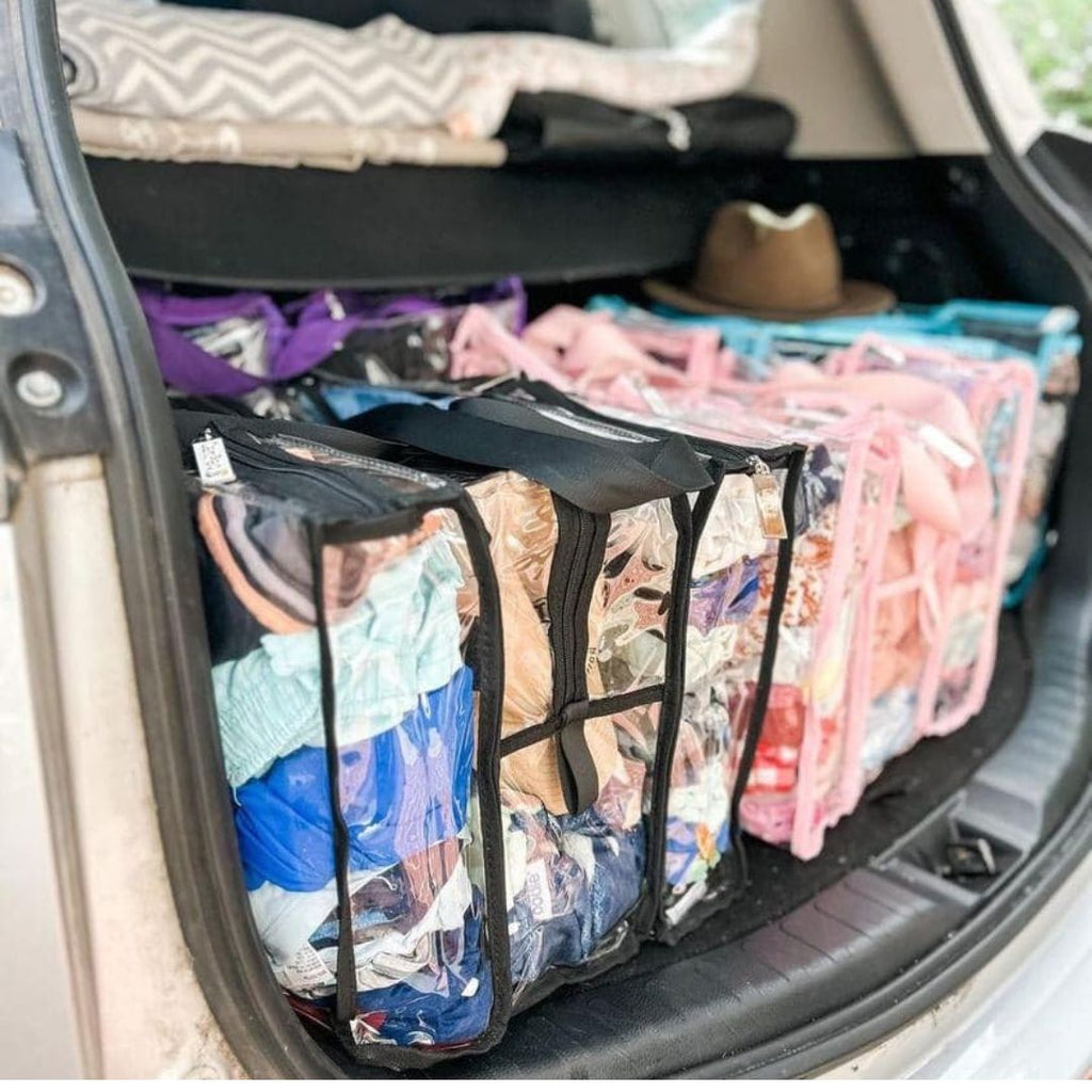 Car boot packCed with  CamPaq bags full of clothes