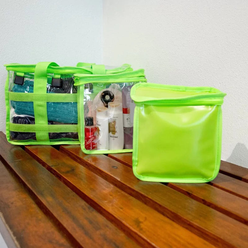 Green clear CamPaq toiletry bag with detachable opaque privacy pocket sitting separately on amenities shower bench