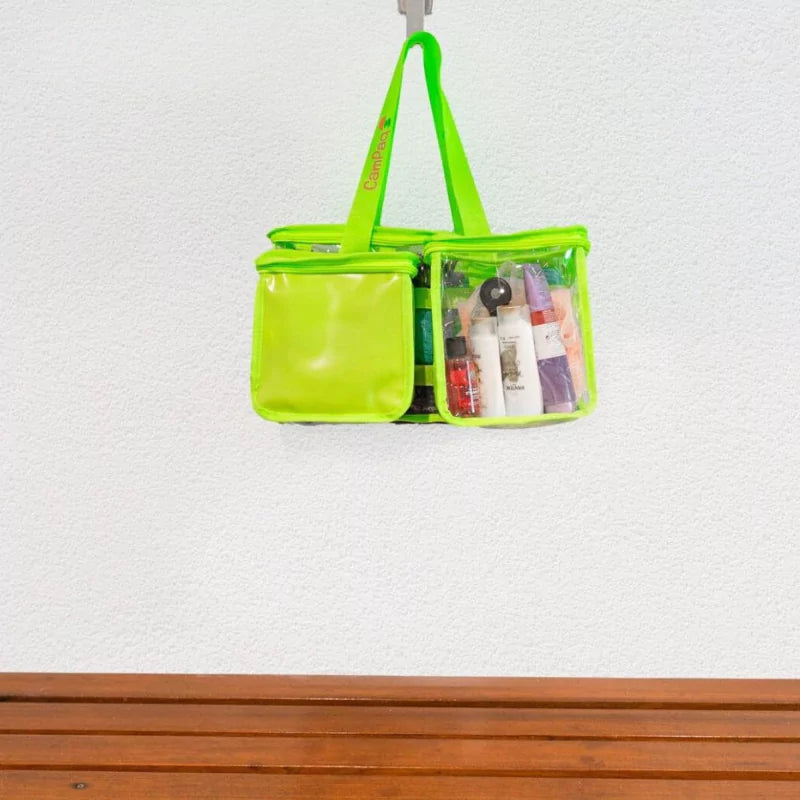 Green clear CamPaq toiletry bag with  opaque privacy pocket and toiletries hanging on bathroom hook on wall