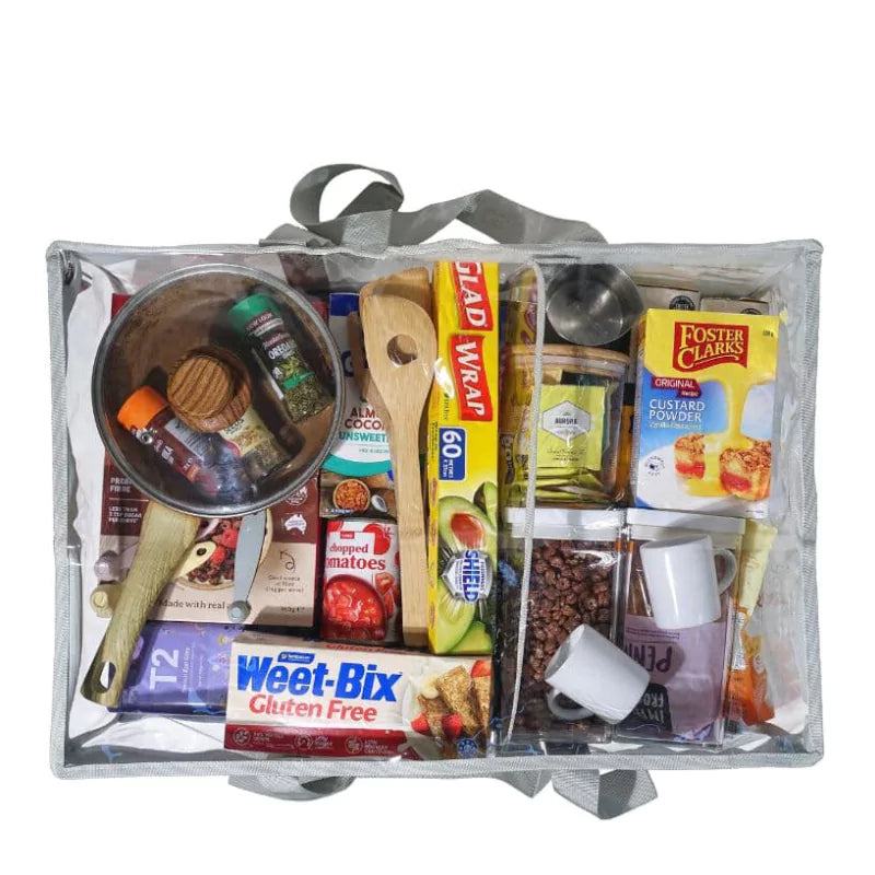 Grey under bed CamPaq clear storage bag top view packed with pantry items and utensils