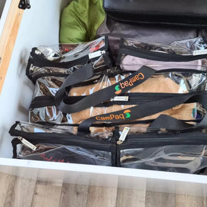 Large black clear camping bag under caravan bed