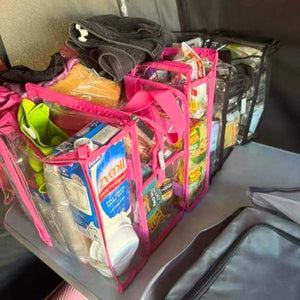 Medium hot pink clear camping bag filled with groceries sitting on tent floor