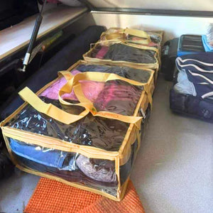 Sand clear under bed storage bag packed with camping gear under camper bed