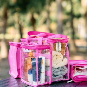Clear hot pink toiletry bag with clear sections filled with toiletries 