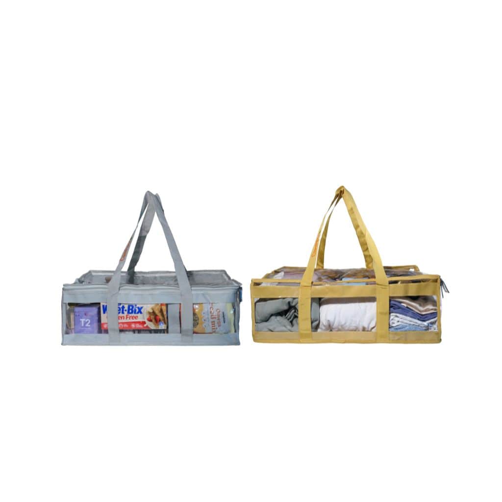 Side view of sand and grey clear CamPaq under bed bags filled with linen and pantry items and handles